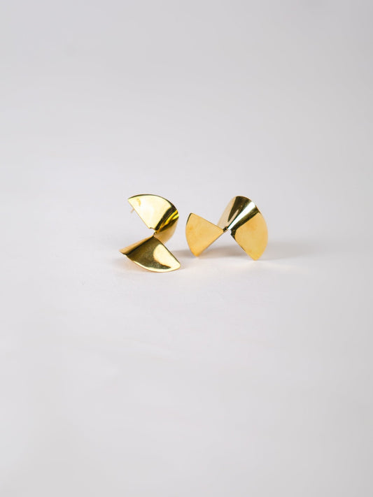 Pair of gold geometric earrings on a light gray background