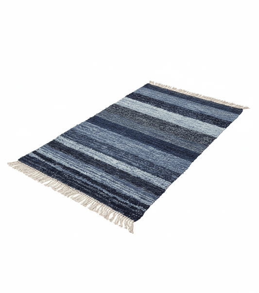 Striped blue rug with white fringe on a white background