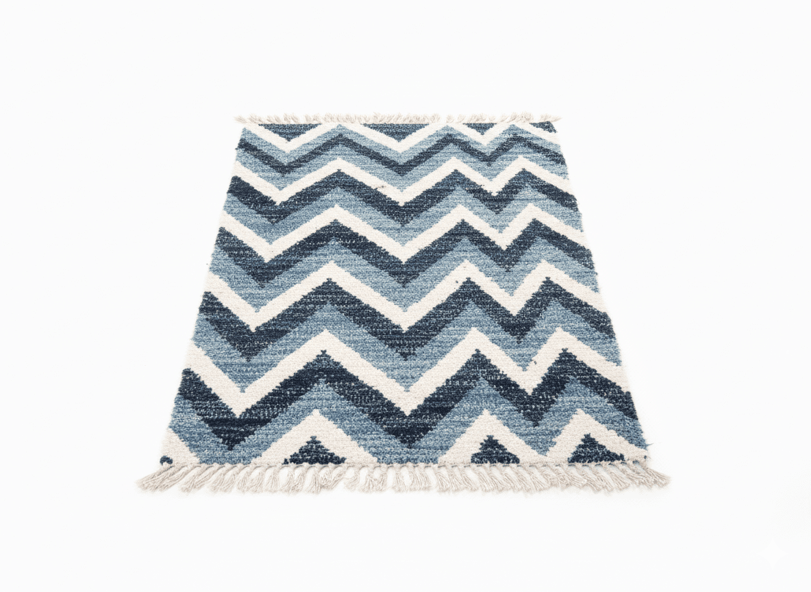 Blue and white zigzag patterned rug with tassels on a white background