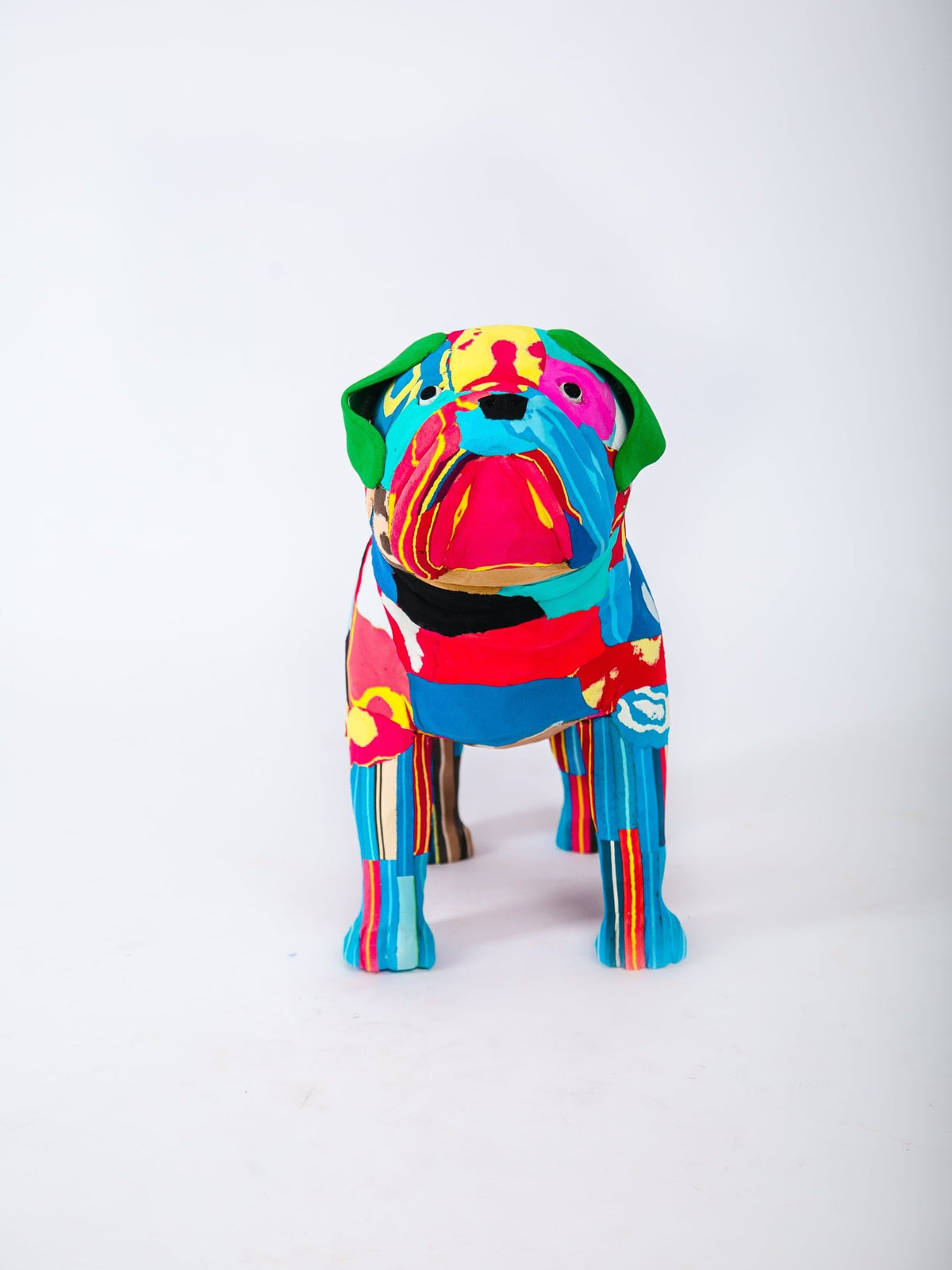 Colorful dog-shaped sculpture on a white background