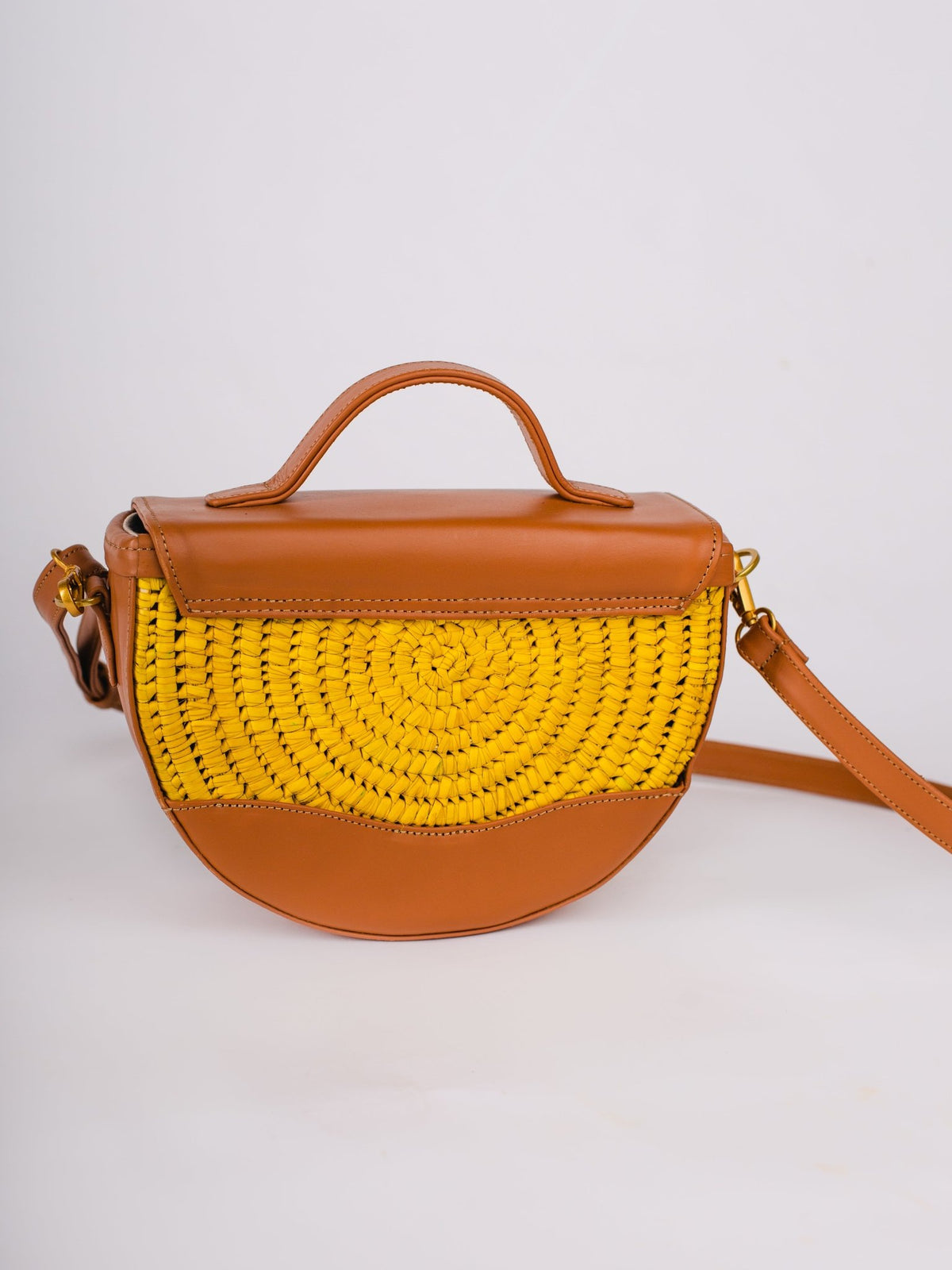 Brown handbag with a yellow woven section on a white background
