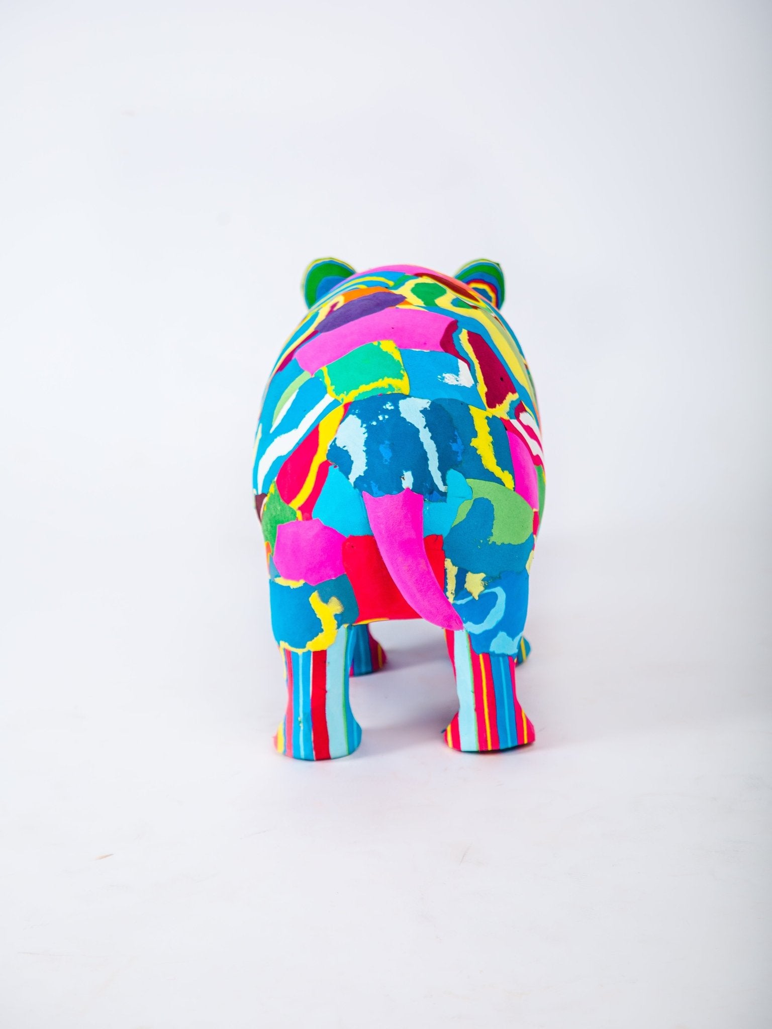 Colourful hippo-shaped sculpture on a white background