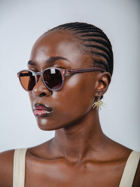 Woman wearing sunglasses with a neutral background