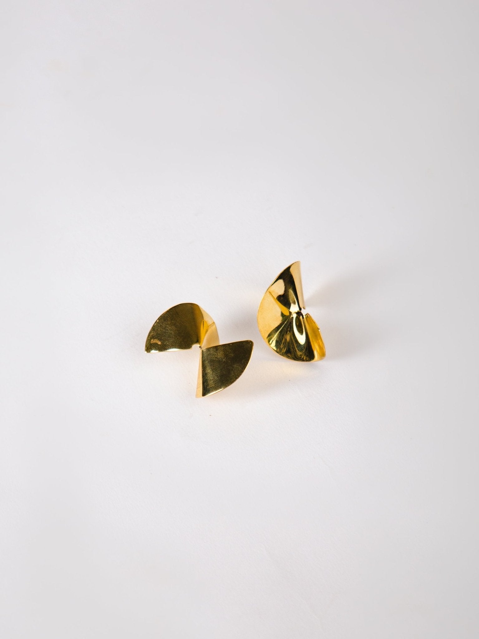 Gold earrings on a white background