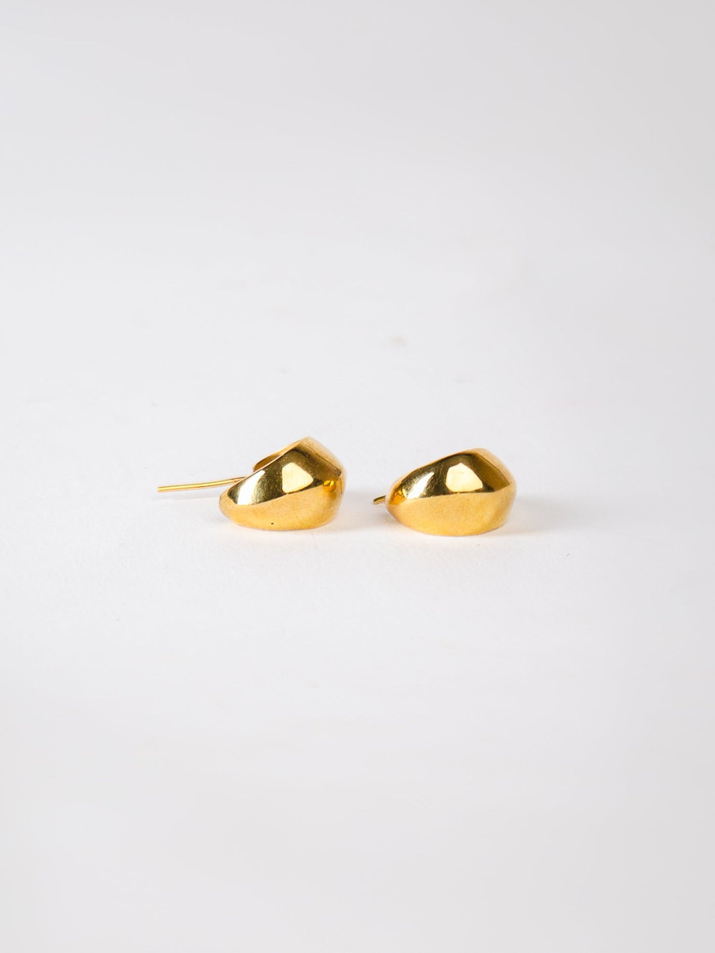 Pair of gold earrings on a white background