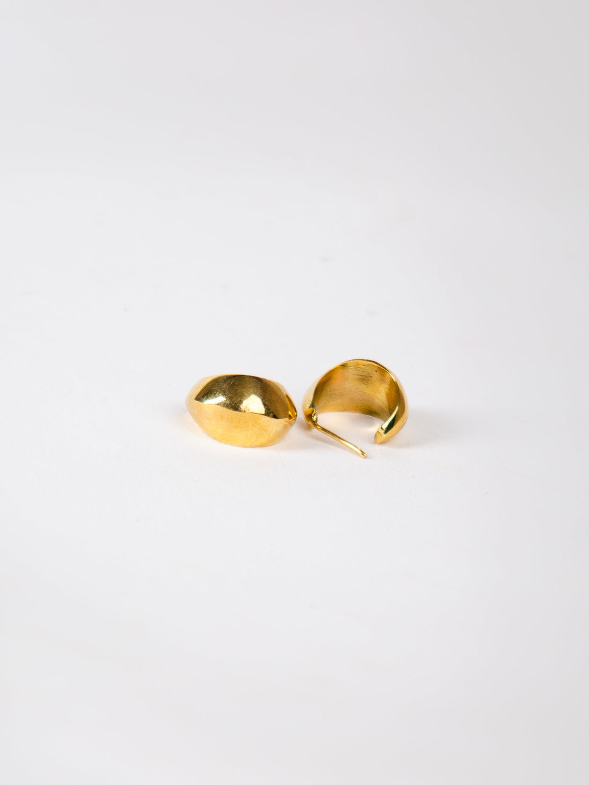 Pair of gold earrings on a white background