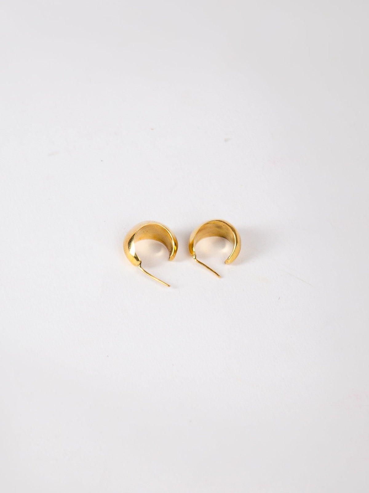 Gold hoop earrings on a white background