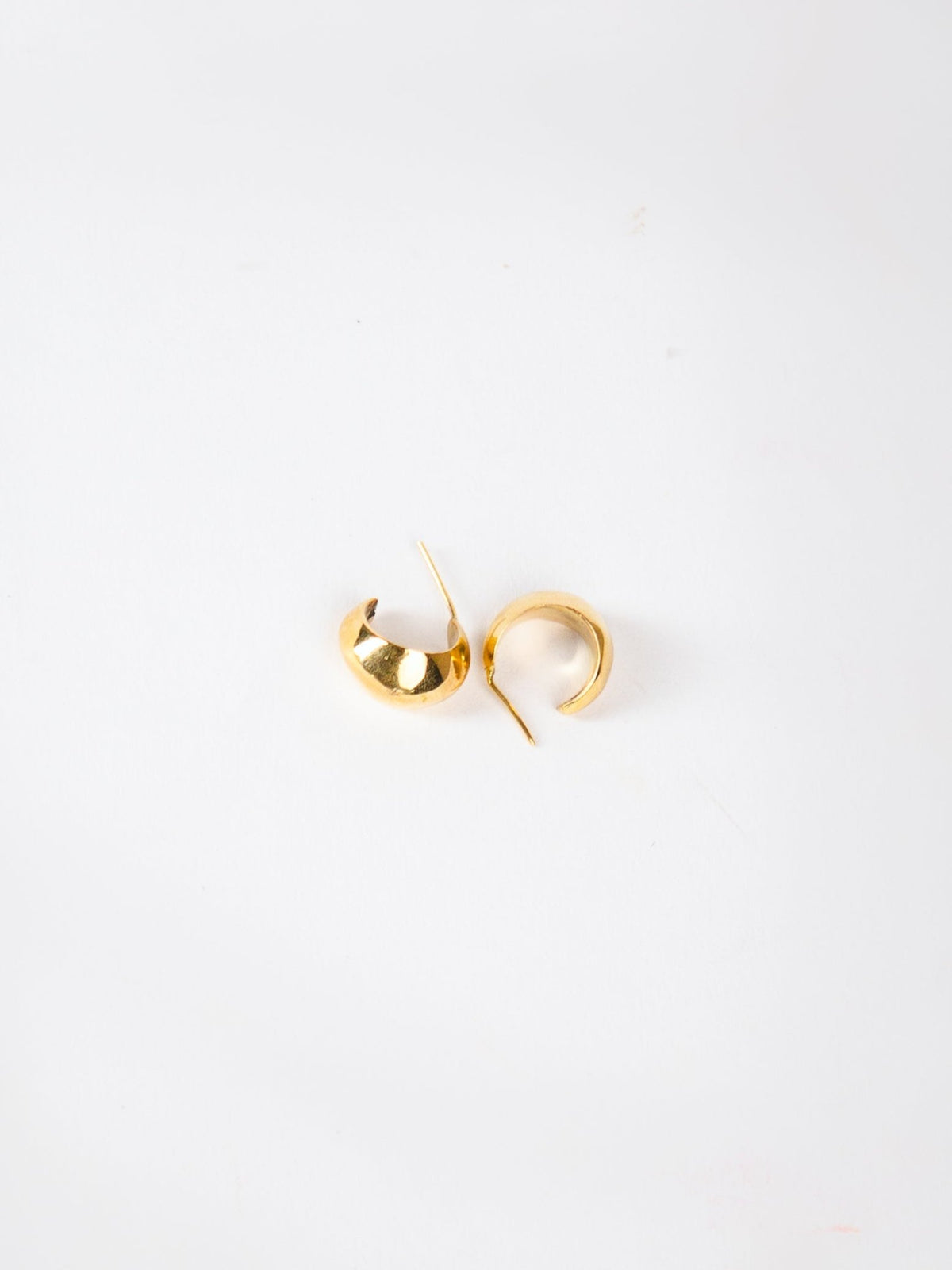Pair of gold hoop earrings on a white background