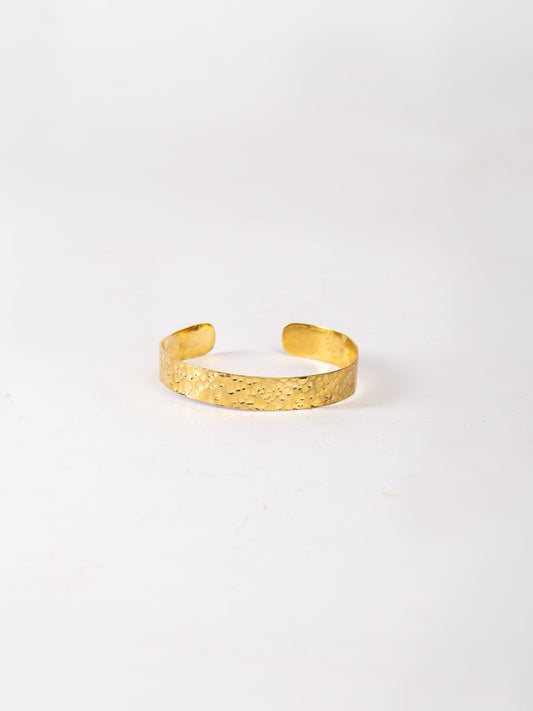 Gold bracelet on a white background