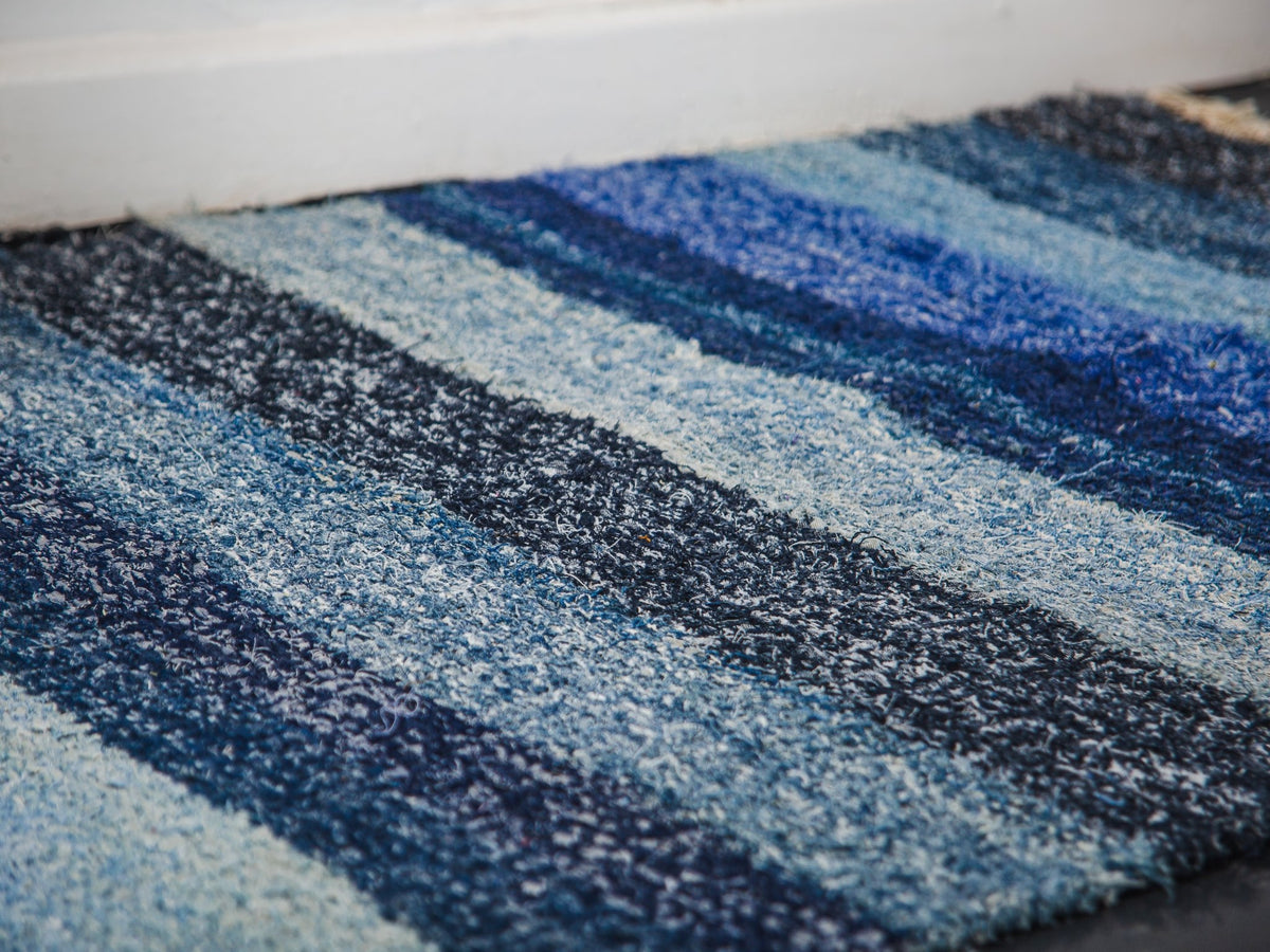 Close-up of a blue and black striped rug