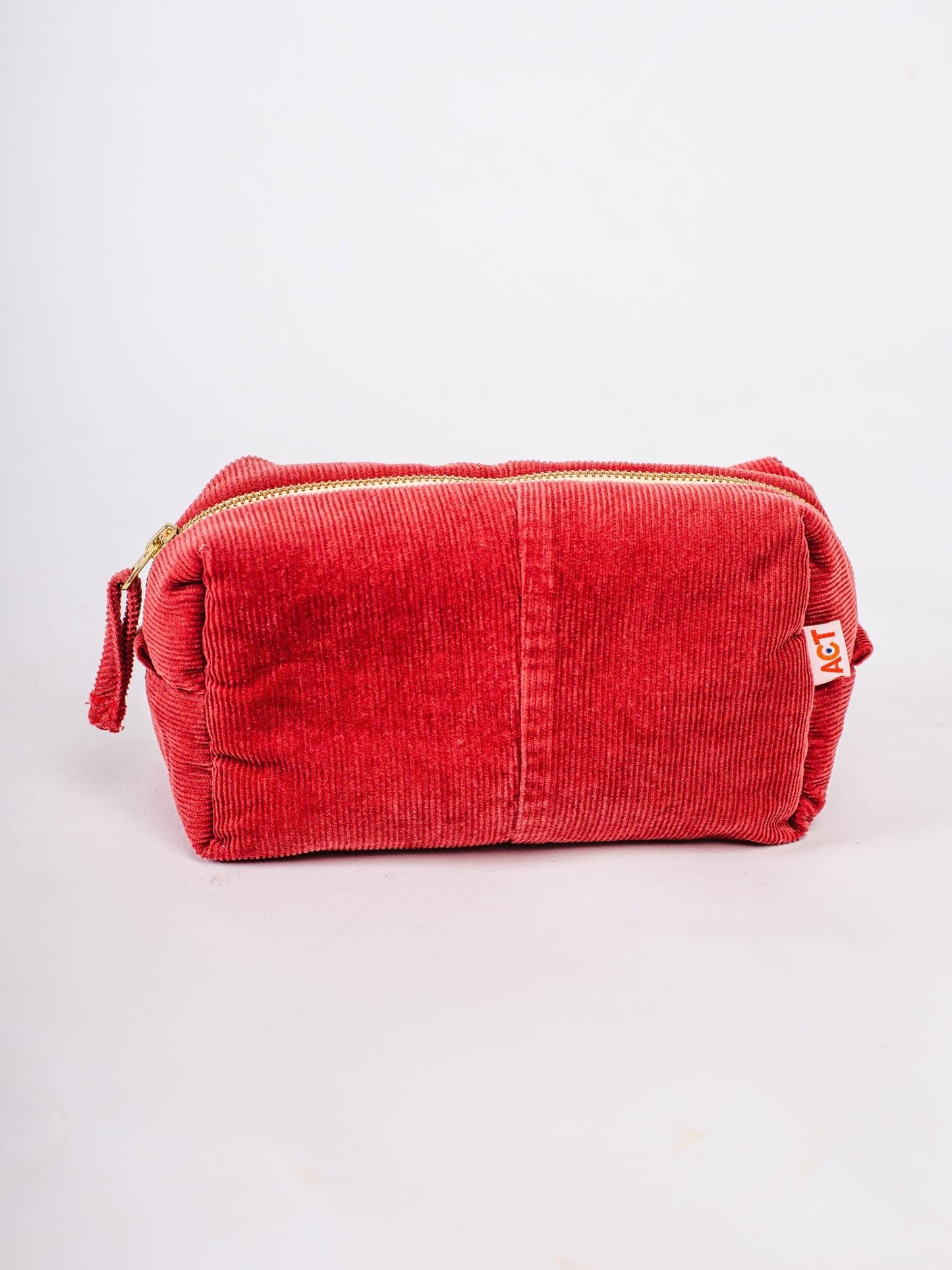 Red corduroy pouch on a light gray background