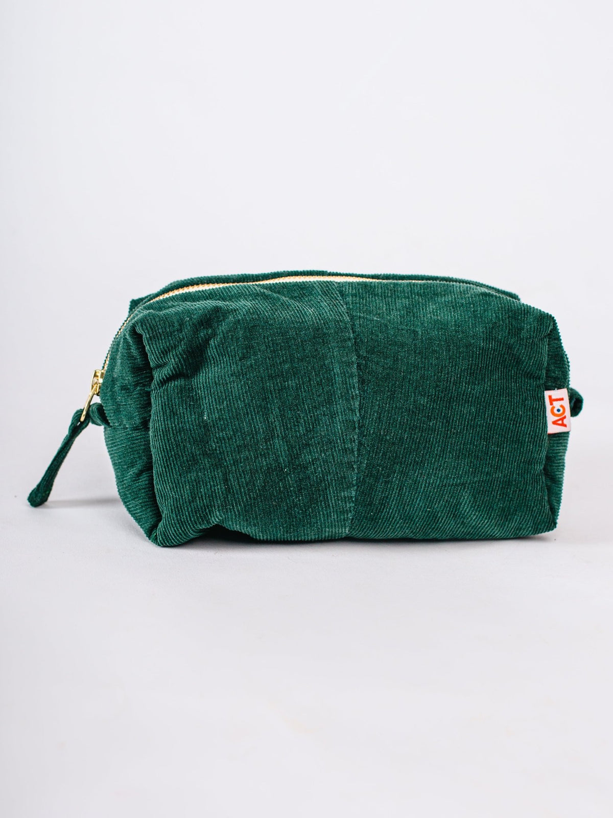 Green textured pouch with a visible brand tag on a white background