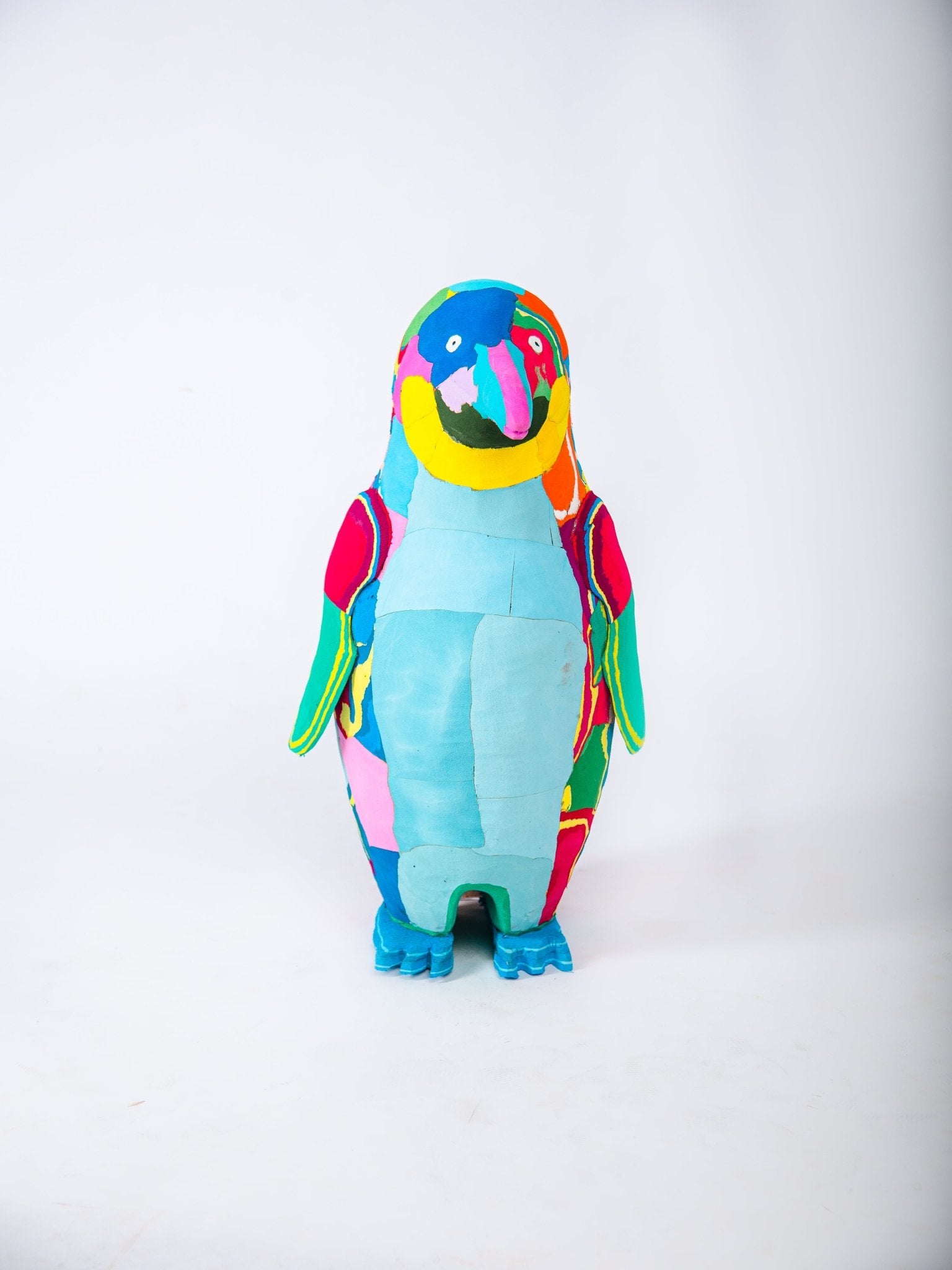 Colourful penguin sculpture on a white background