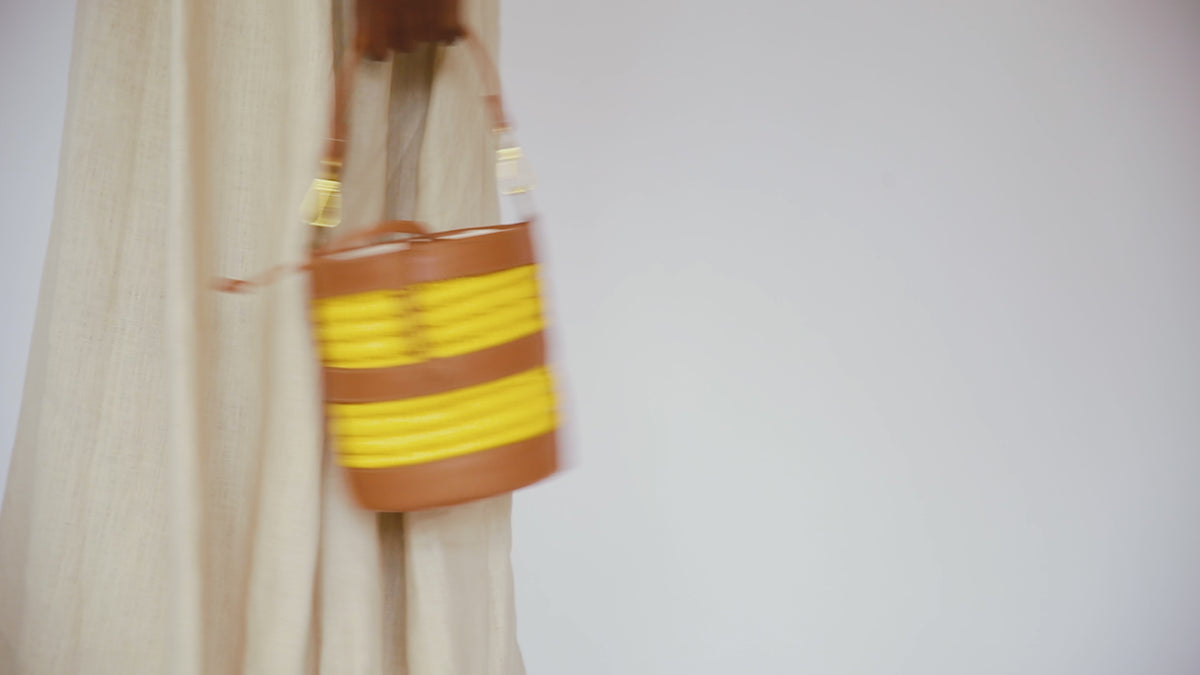 woman moving and carrying a bucket bag