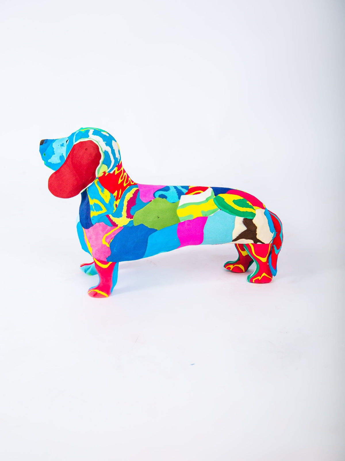 Colorful dachshund-shaped object on a white background