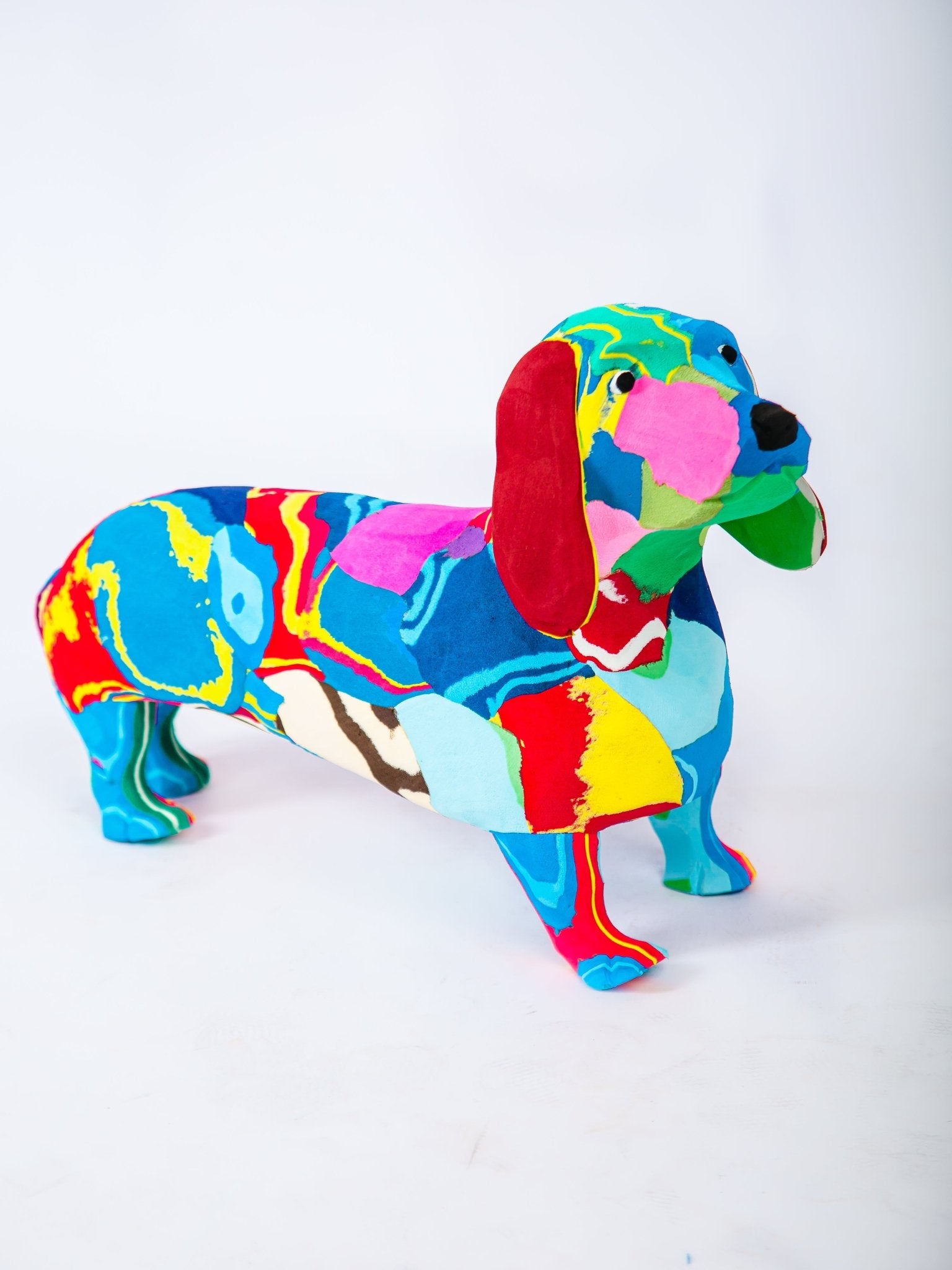 Colorful dachshund figurine on a white background