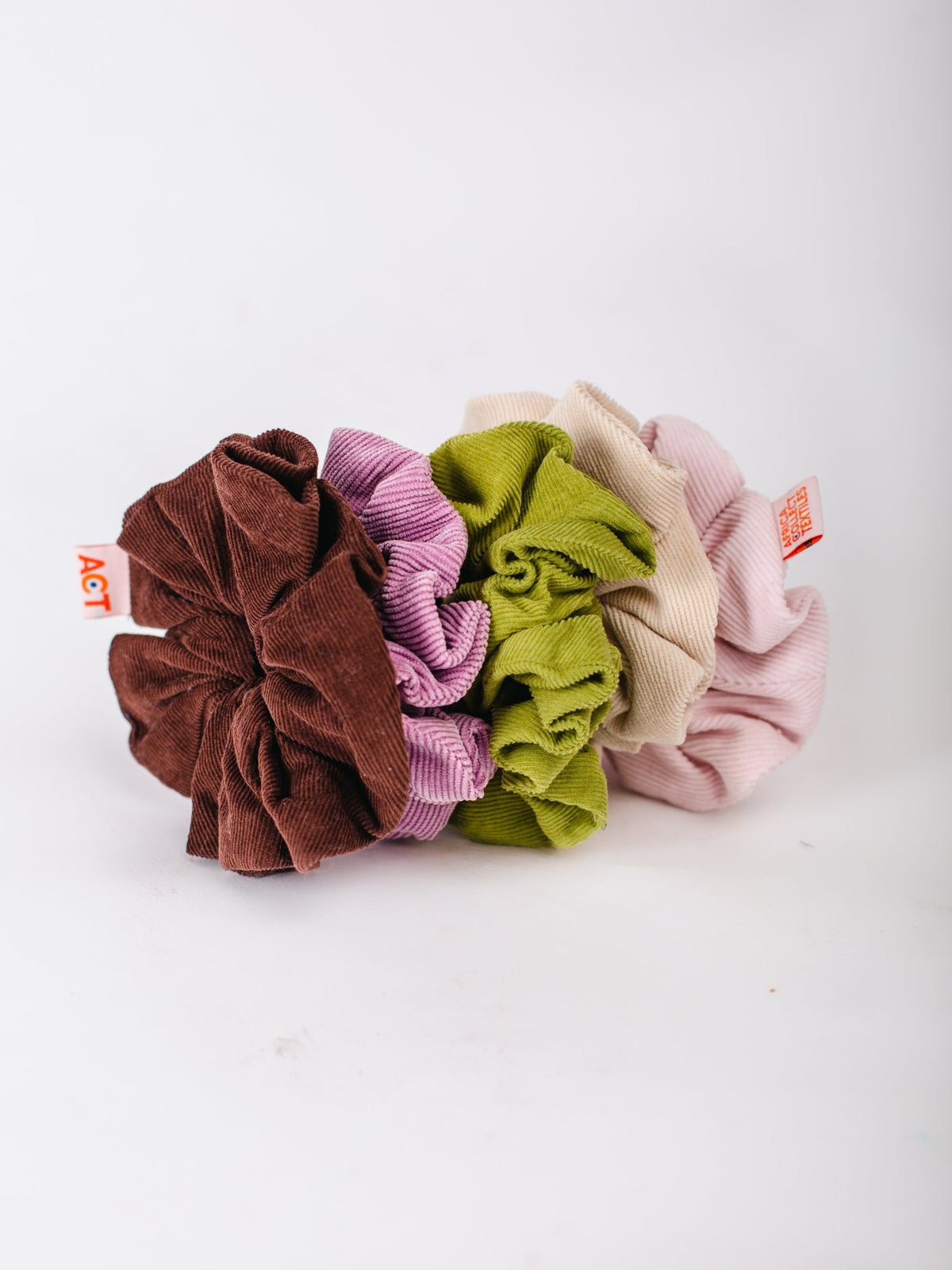 Set of five colorful scrunchies on a white background