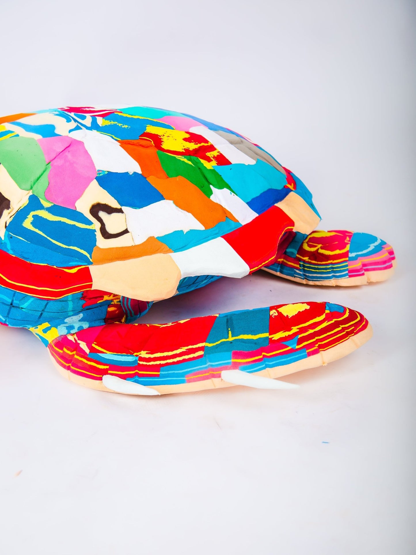 Colourful patterned sculpture on a white background