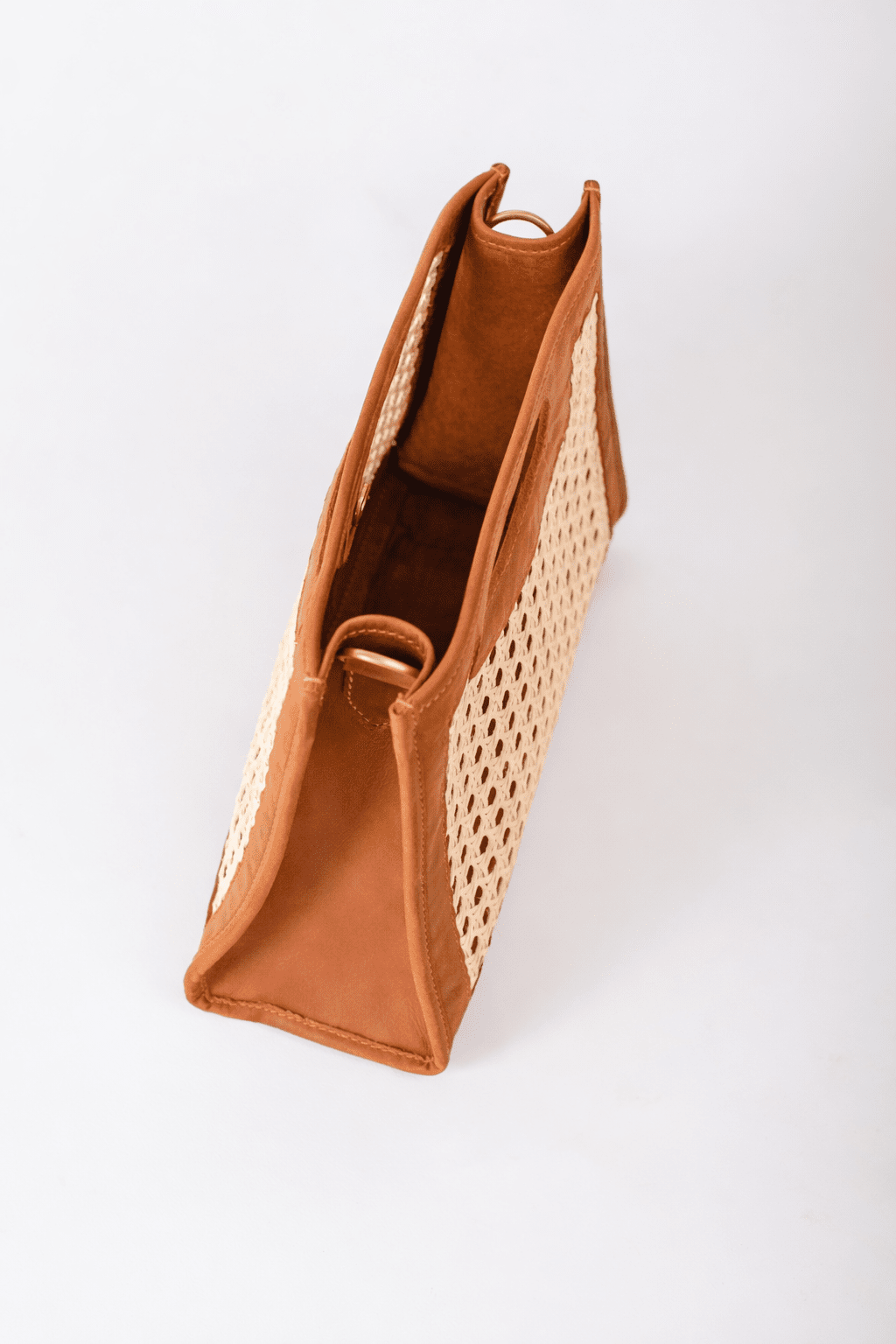Brown perforated handbag on a white background