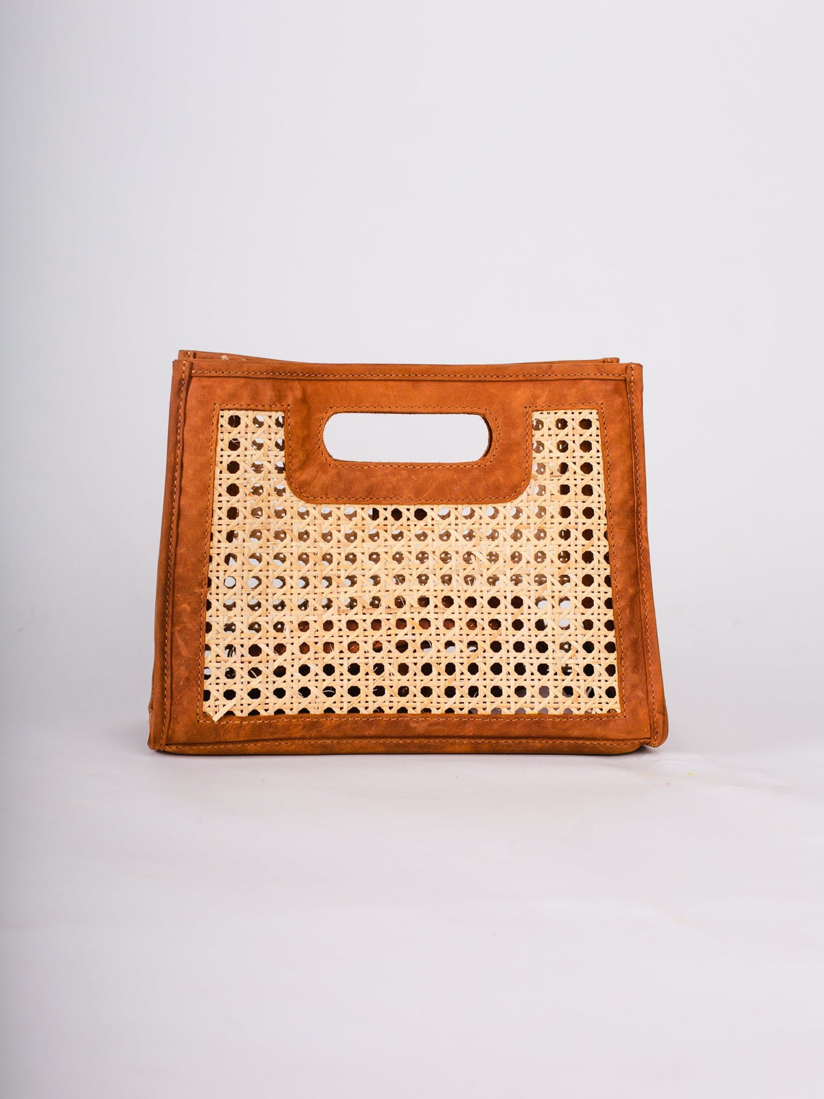 Brown handbag with woven design on a white background