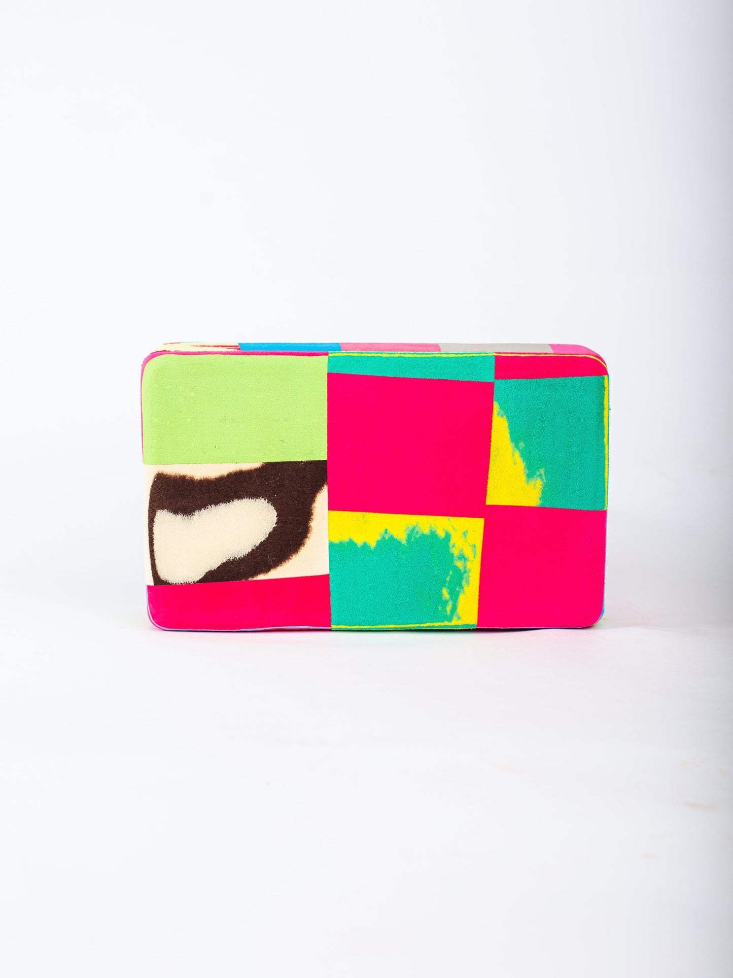 Colourful patchwork yoga block with a white background